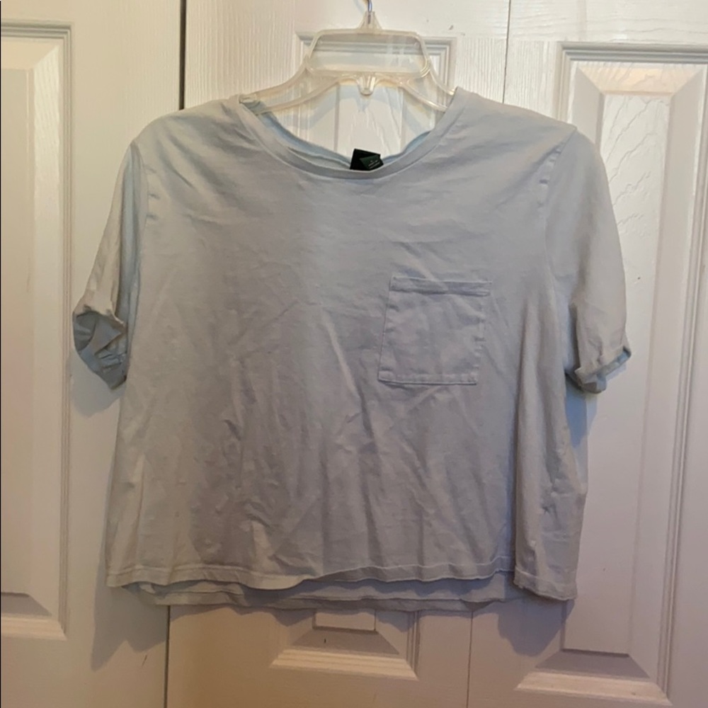 Light blue crop top with pocket on the left side.